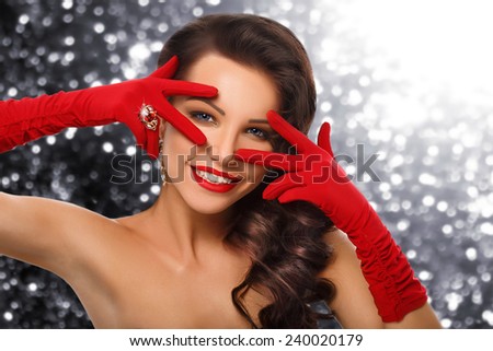 Beauty Fashion Glamorous Model Girl Portrait. Vintage Style Mysterious Woman Wearing Red Glamour Gloves. Jewellery. Jewelry. Holiday Hairstyle and Make-up. Diamond Ring. Retro Lady with Blue Eyes
