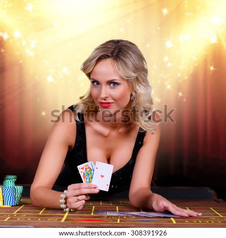 Girl playing in casino.girl holding the winning combination of poker cards