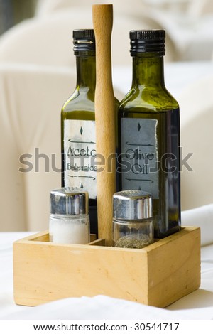 Olive oil and vinegar in a restaurant with white cover