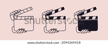 A set of clapperboards in hands. Hands are holding an open director's clapboard isolated. Vector illustration of a tool for filming and editing video.