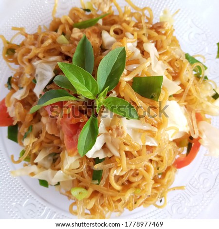 Javanese fried noodles, home-cooked noodles mixed with sautéed garlic, pepper, ebi, cabbage, leeks, celery, tomatoes with basil leaves topping ... it was very delicious Photo stock © 