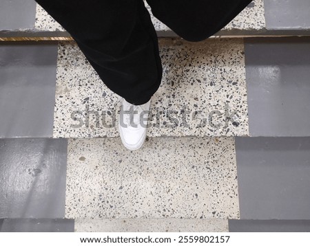 Similar – Image, Stock Photo Black pants, sneakers, legs stand with shadow on pavement