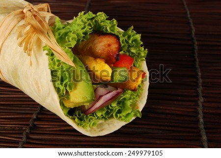 Wrap sandwich : Grilled chicken avocado wrap sandwich, wooden mat