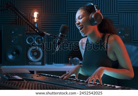 Image, Stock Photo Smiling woman playing piano in living room