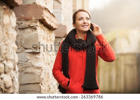 Young woman having a relaxing walk and talking on the phone