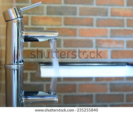 faucet water motion brick background