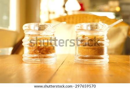 organic brown sugar in clear jar on wood table