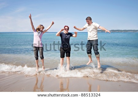 man, woman and child freedom jump in water