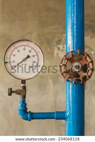 Water pressure meter installed on a blue pipe