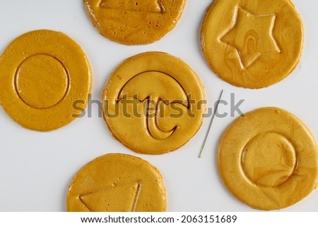 Top view Dalgona or Ppopgi candy, honeycomb toffee sugar candy with round, star, umbrella and triangle shape with needle on white background