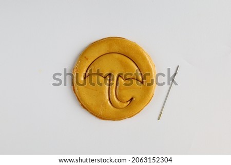 Top view Dalgona or Ppopgi candy, honeycomb toffee sugar candy with umbrella shape with needle on white background