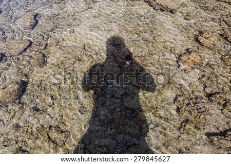 The photo of my shadow on the beach with water