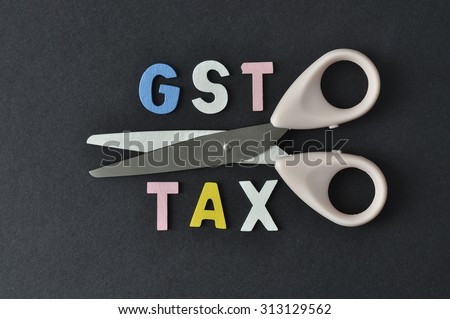 Scissor and word of GST and TAX on black background