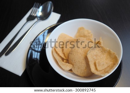 Crisp rice in a bowl with spoon and fork. Thai snack.