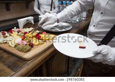 waiter Serving cheese on a plate