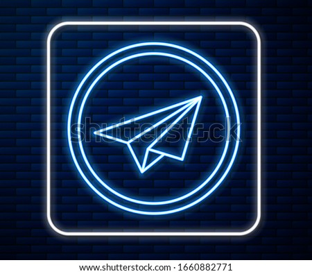 Glowing neon line Paper plane icon isolated on brick wall background. Paper airplane icon. Aircraft sign.  Vector Illustration