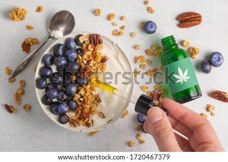 Cannabis infused granola, blueberry and greek yogurt. CBD smoothie bowl recipe for the chillest summer breakfast. Start your morning wth a few drops of CBD oil for a health and wellness kick start.