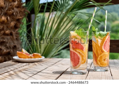 Similar – Foto Bild Grapefruit-Kaltgetränk und Grapefruitscheiben im Sonnenlicht