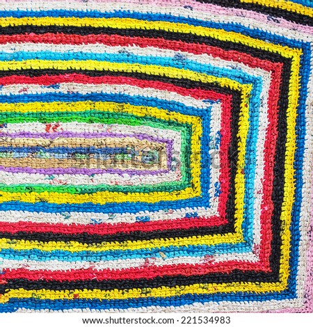 Colorful hand made knitted rug. Reuse of supermarket plastic bag, package. Folk nation creativity. Rustic style. Rough texture  and bright design