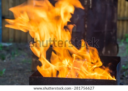 Fire with flames in a metal brazier for kebab