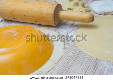 rolling pin with dough and flour on a table. Preparing a baking