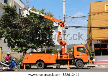 CHIANGMAI,THAILAND-26 SEPTEMBER:May the work of cutting branches near power wires, low voltage.26 september 2015