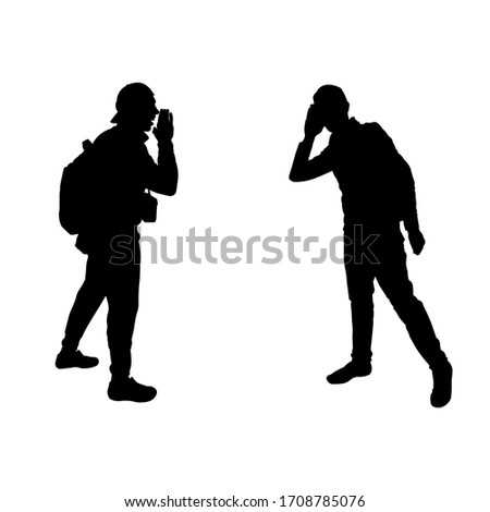 Black silhouette of men.  The man yells for another. The man tries to hear. Understanding people. Teamwork. Tourists, travelers, climbers, adventurers, hiking. Mountain trip.
