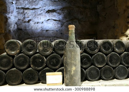 Old bottle of wine in the cellar of the winery\
Ancient wine bottles in the cellar\
Winery\
Red wine of ancient times