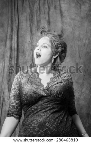 A woman making a crazy facial expression while shaking powder out of her hair. Her mouth open. Powder exploding everywhere.