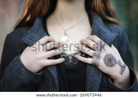 Adolescence. Girl with a temporary drawn tattoo on her hand.