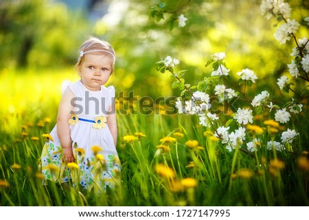 девочка ребенок гуляет весной в саду, яблоня цветет, цветение, май  Сток-фото © 