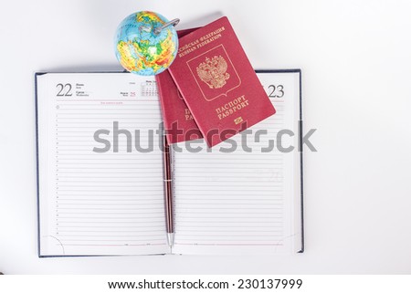 Opened lined diary with two internation passports and globe