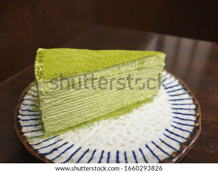 Similar – Image, Stock Photo Matcha cheesecake on pink background. Single slice of cake