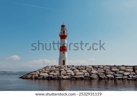 Similar – Foto Bild Einsamer Leuchtturm an felsiger Küste am Morgen