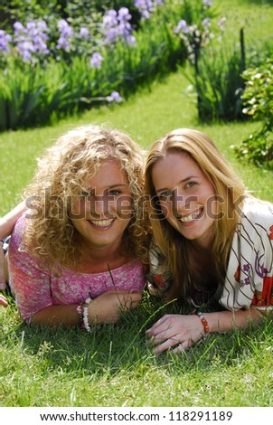 Confident woman friend sharing in a garden.Two women in nature.