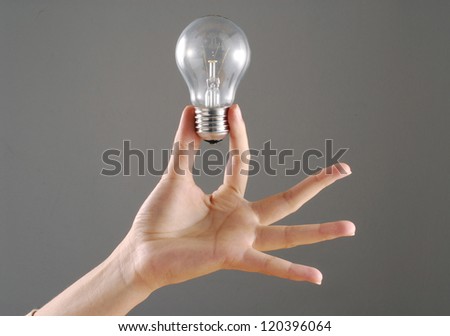 Young female hand holding a bulb.
