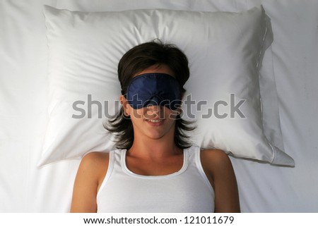 Beautiful sleeping young woman in sleep eye mask.