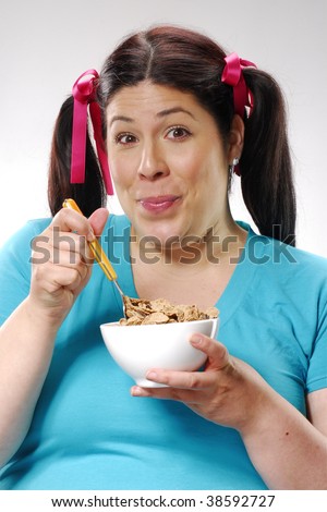 Fat woman holding a cereal bowl,woman eating cereal,