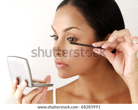 Latin woman applying makeup powder on white background,latin woman makeup.