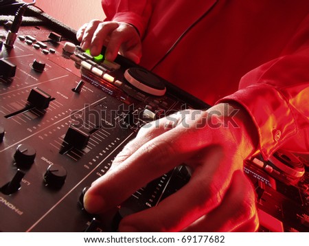 Working Disc jockey at party. Detail of a disc jockey  hands.
