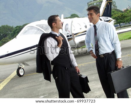 Business people working outsider on private jet background.