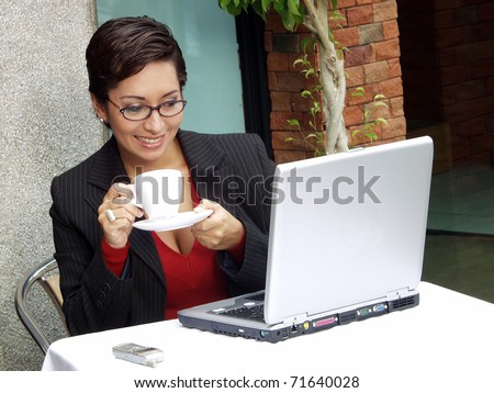 Businesswoman woman in a restaurant working on a computer.