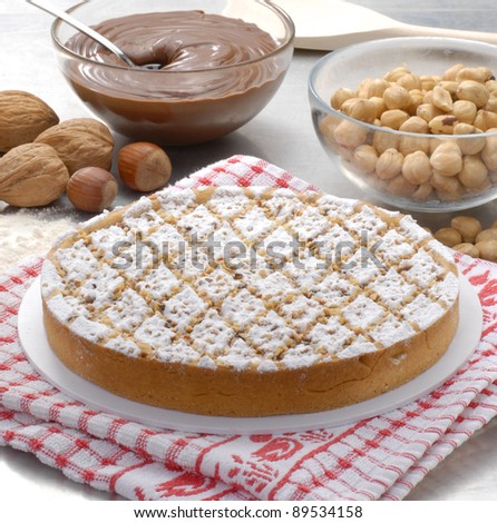 Fresh nuts cake on a table and nuts cream.