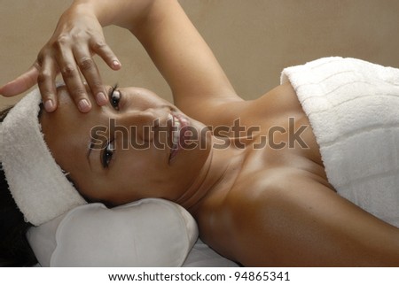 Beautiful young afro woman at beauty salon spa getting a body treatment. Beautiful young black woman at beauty salon spa getting a body treatment.