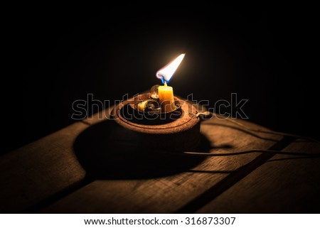 Candle lamp burning with a soft glow light