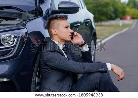 sad businessman use smartphone sitting on road near the broken car opened the hood, calling car assistance services, help repair stress problem emergency insurance aut Stock fotó © 