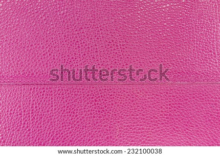Close up background realistic pink high quality leather texture surface with double seam at the middle