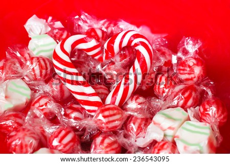 Peppermint candy heart over christmas peppermint candies on red plate