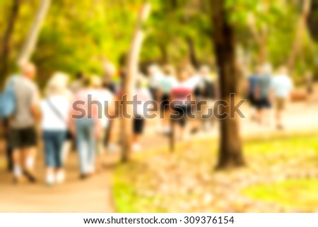 group of old and healthy people walking in the nature, blurred