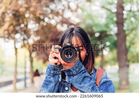 Similar – Image, Stock Photo Unrecognizable photographer taking photo on camera near wall outdoors